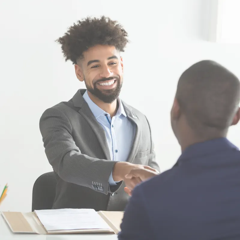 A recruiter shakes hands with a candidate at the end of an interview