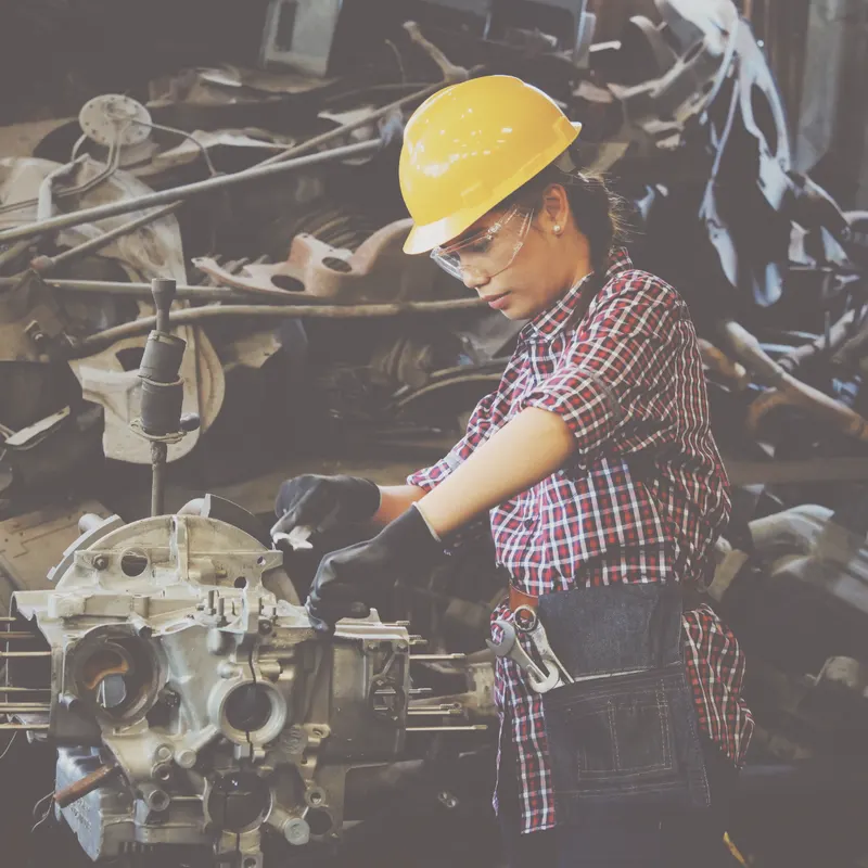A worker in a hard hat in a manufacturing plant